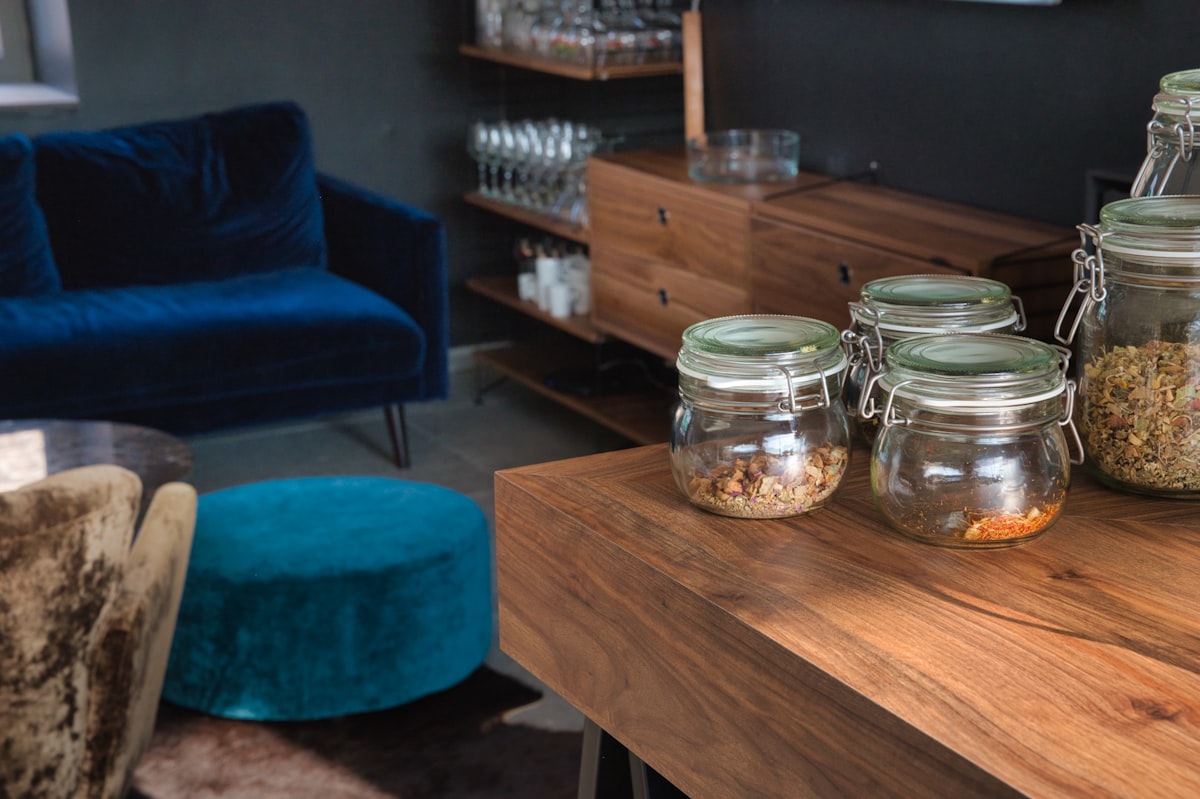 clear glass jar on brown wooden table related to Elevate Your Dining Room with Walnut Sideboards and Buffets