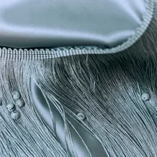 Close-up details of lace, beads, pearls, and threads used in fashion and tailoring. High-quality textile elements and handmade embellishments, showcasing the craftsmanship and elegance of garment design. Perfect for illustrating couture, sewing, fashion production, and artisanal clothing aesthetics. related to Twin Matelasse Coverlet Sale | Discounted Prices