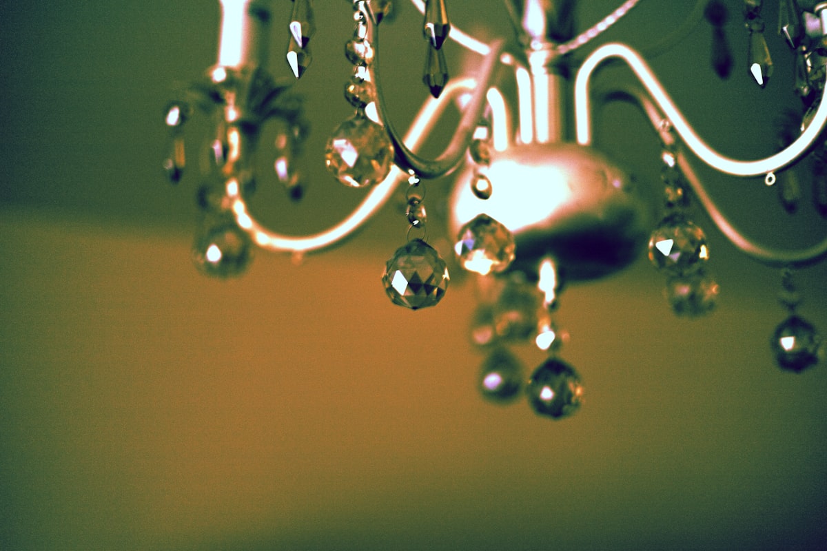 Close-up of a decorative chandelier with crystal accents. related to Elegant Window Dressing: A Guide on How to Hang a Window Scarf Valance