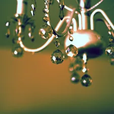 Close-up of a decorative chandelier with crystal accents. related to Elegant Window Dressing: A Guide on How to Hang a Window Scarf Valance