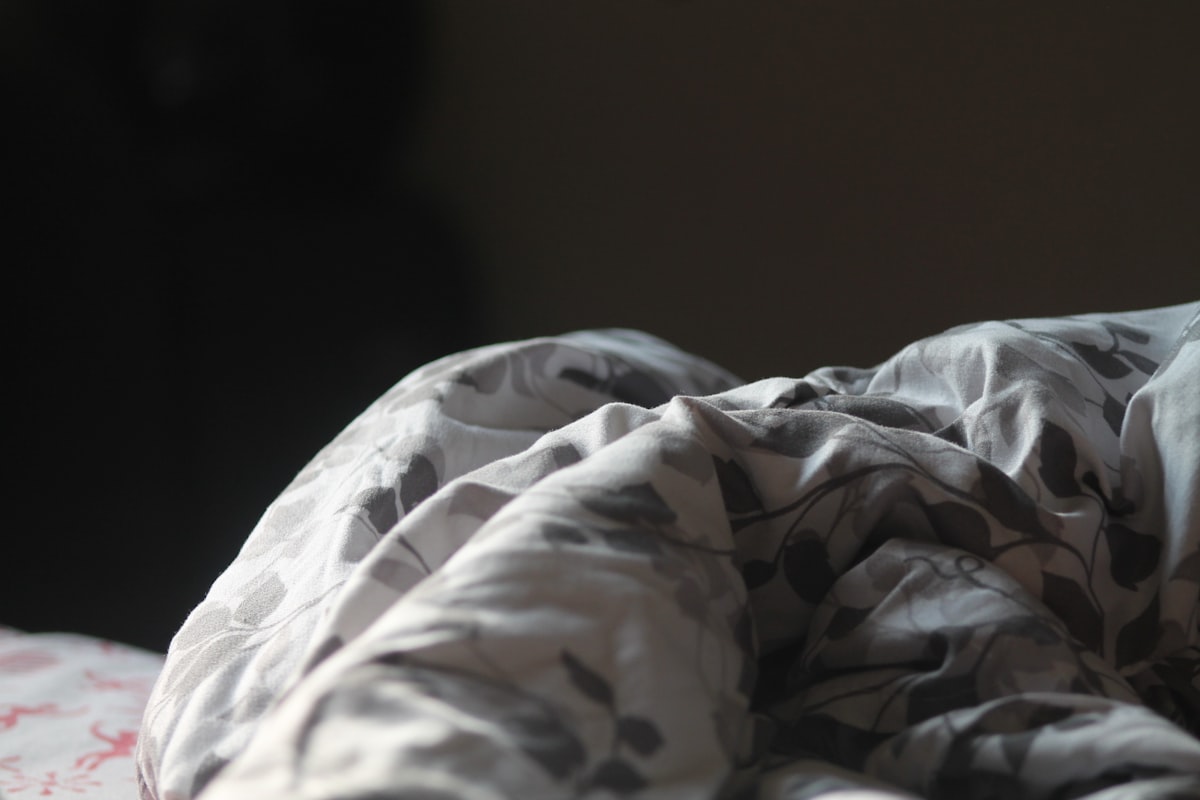 Close up of a folded blanket with a floral pattern. related to Chill Out with Light Blue Bedding