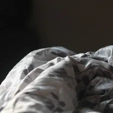 Close up of a folded blanket with a floral pattern. related to Chill Out with Light Blue Bedding