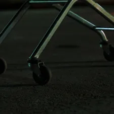 Close-up of a metal cart with four wheels related to The Ultimate Guide to Bed Frame Casters: Enhance Mobility and Style