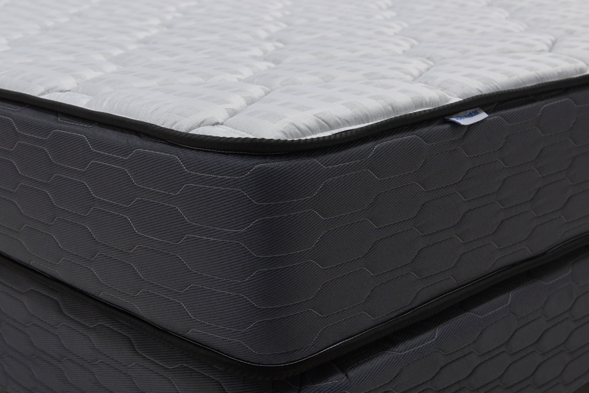 Close-up of a modern mattress with a dark patterned base. related to Galaxy Bed Set For Deep Night Sky Nightscape