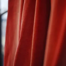 Close-up of flowing red velvet curtains related to Styling Ideas for Red Curtains with Valance