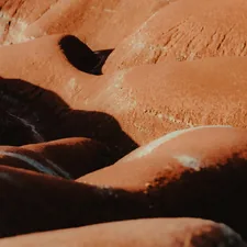 Close-up of textured orange rocks in sunlight. related to The Hidden Dangers of Tanning Beds: What You Need to Know