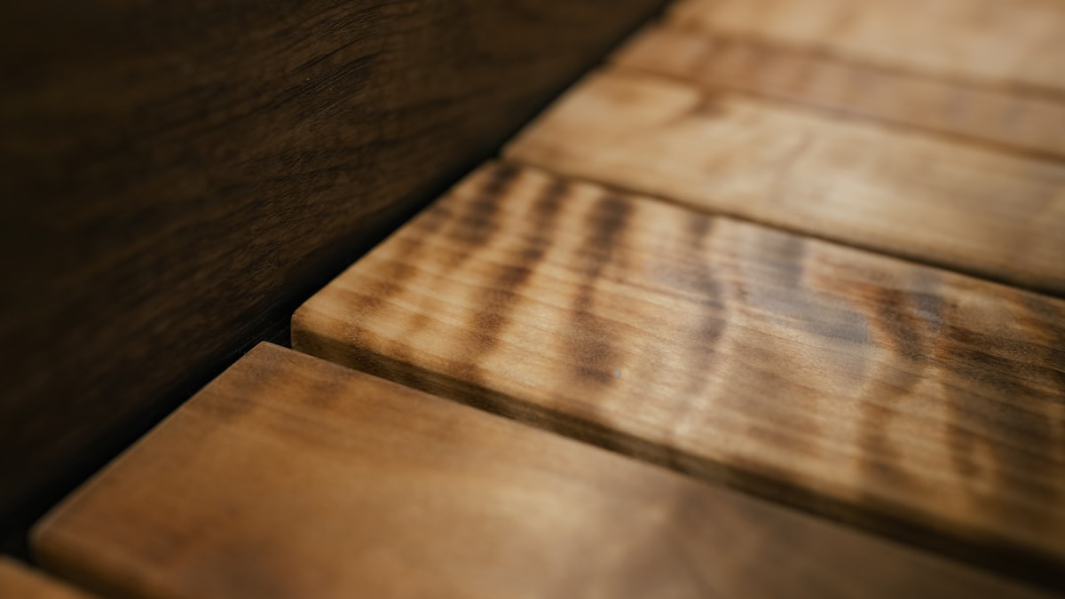 Close-up of wooden planks with a rich, textured grain pattern and warm, natural tones. related to Elegance Meets Durability: Solid Wood Sideboards for Your Home