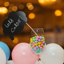 colorful candy in a wine glass related to Add a Pop of Color to Your Space with a Hot Pink Valance