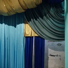 Colorful fabrics drape in a theatrical arrangement. related to Valances and Curtains: Elevating Your Home's Style