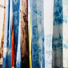 Colorful fabrics hanging and drying in sunlight. related to Tie Dye Bed Sheets: A Burst of Color for Your Bedroom Oasis