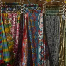 Colorful patterned fabrics hanging on display related to Hanging Scarf Valances: Elevate Your Home Decor