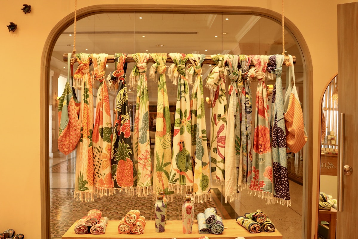 Colorful scarves are displayed in a store. related to Hang Scarf Valance Curtains Like a Pro