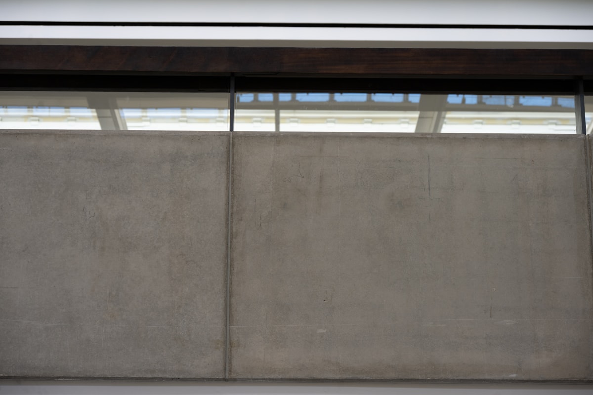 Concrete wall with a modern window above related to A Comprehensive Guide to Window Blind Valance Clips