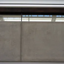 Concrete wall with a modern window above related to A Comprehensive Guide to Window Blind Valance Clips