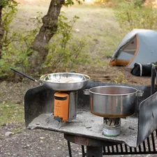Cooking food in the wilderness with a BioLite during a camping trip related to Outdoor Cooking Chiminea