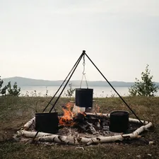 cooking outdoor dinner on a bonfire near the lake and mountains. Film shoot.🌟 Your Creative Projects Await! 🌟 If you’ve used this photo in your work, I’d love to see it! Please send a link to your project via email at dinabdmsh@gmail.com Your creativity inspires me, and I’m excited to see how you’ve brought this image to life. If you appreciate my work and would like to support me, feel free to check out my donation link https://paypal.me/dinamazing Thank you! related to The Magic of Outdoor Cooking: Mastering Chiminea Cuisine