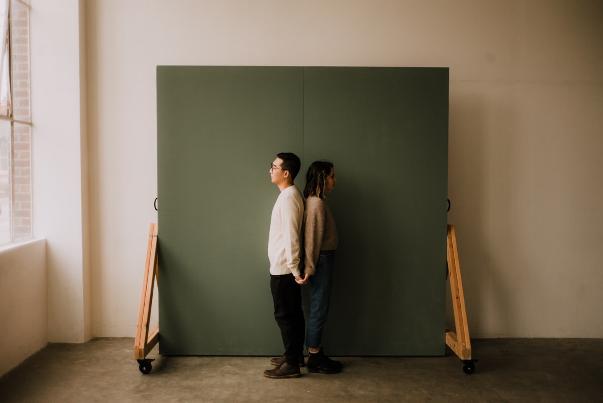 couple holding hands back to back in a natural light studio in seattle related to DIY Murphy Bed: The Ultimate Space-Saving Solution