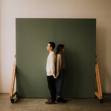 couple holding hands back to back in a natural light studio in seattle related to DIY Murphy Bed: The Ultimate Space-Saving Solution