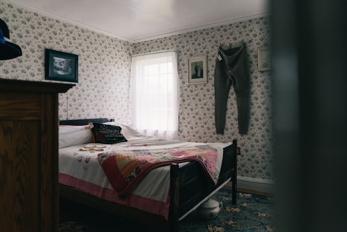 Cozy bedroom with floral wallpaper, bed, and bright window. related to Exploring Bed-Stuy Real Estate: The New Hotspot for Investors and Homebuyers