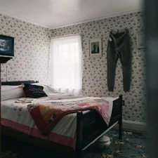Cozy bedroom with floral wallpaper, bed, and bright window. related to Exploring Bed-Stuy Real Estate: The New Hotspot for Investors and Homebuyers