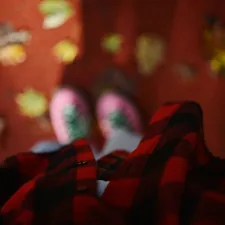 Cozy flannel shirt and socks with autumn leaves related to The Bold Beauty of Red and Black Plaid Bedding: A Trendy Touch for Your Bedroom