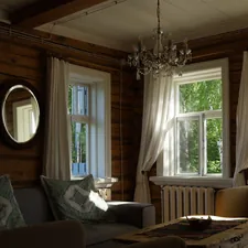 Cozy living room with rustic wooden walls and bright windows. related to Country Valances & Swags
