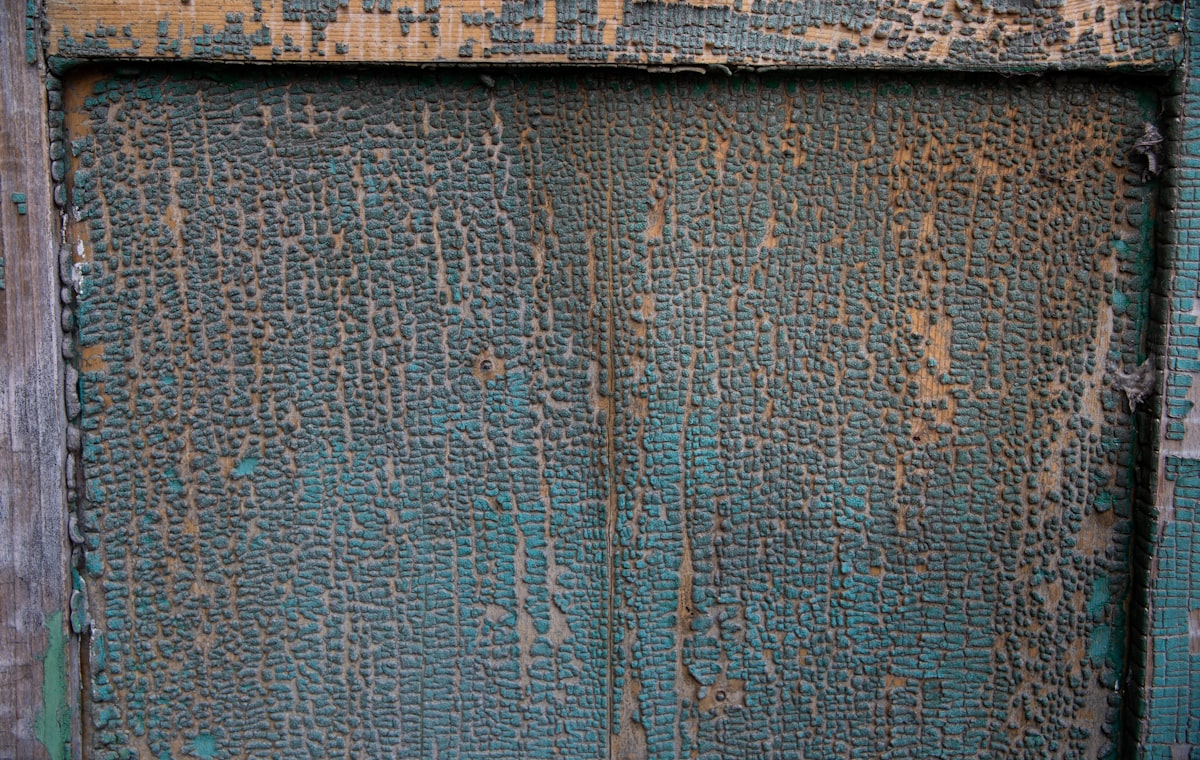 Cracked blue paint on a wood panel. related to Crafting Charisma: Distressed Wood Sideboards for the Home