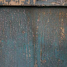 Cracked blue paint on a wood panel. related to Crafting Charisma: Distressed Wood Sideboards for the Home