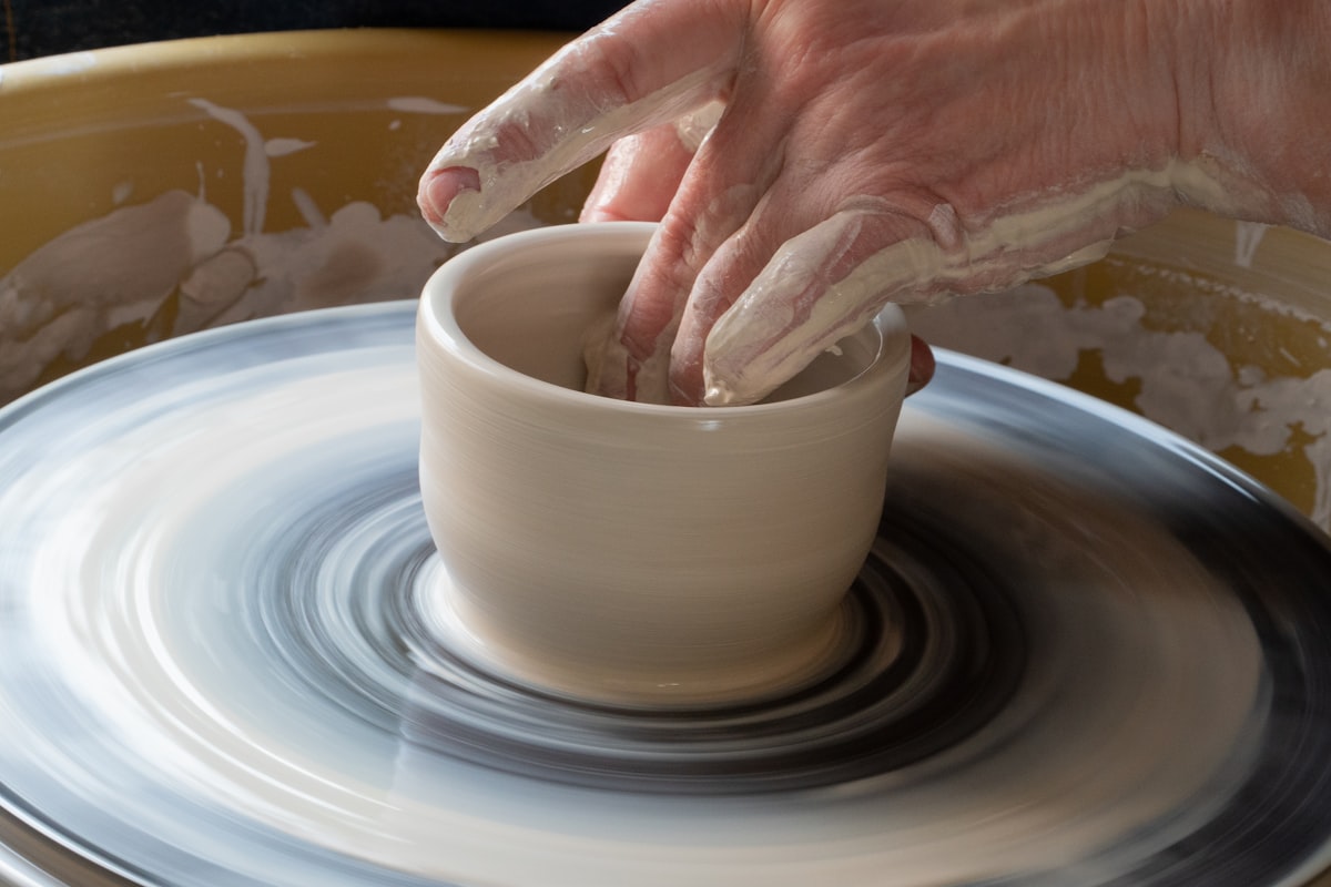 Creating cups on a potter's wheel. related to Curating the Perfect Pottery Barn Nursery Bedding
