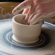 Creating cups on a potter's wheel. related to Curating the Perfect Pottery Barn Nursery Bedding