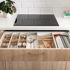 Cutlery drawer in a wooden and white kitchen with wooden drawer inserts. related to Maximizing Storage Space with Drawers Under Bed