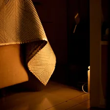 Dark bedroom illuminated by orange light. related to King Bed Coverlet: Elevate Your Bedroom Style