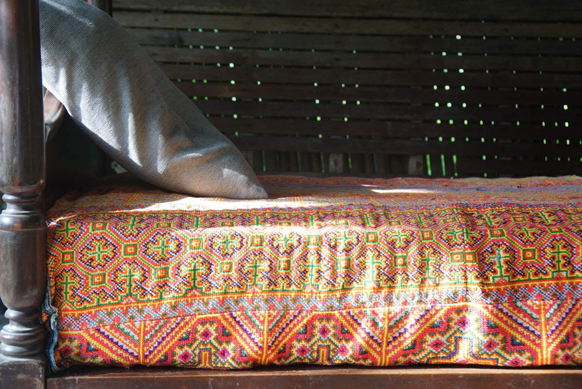 Day bed with colorful folk textile in morning sun related to Transform Your Space with Daybed Coverlets Sets: A Comprehensive Guide