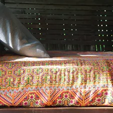 Day bed with colorful folk textile in morning sun related to Transform Your Space with Daybed Coverlets Sets: A Comprehensive Guide