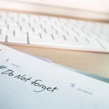 Desk with a keyboard and a diary with the hashtag #DoNotForget on it related to Techniques to Improve Stamina and Endurance in Intimacy