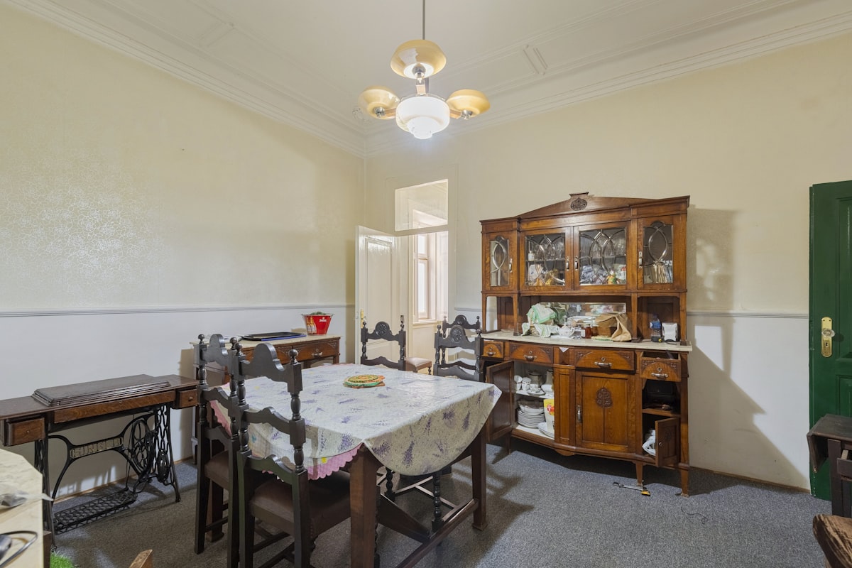 Dining room with vintage furniture and a sewing machine. related to Elevate Your Dining Room with a Stylish Buffet Sideboard