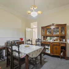 Dining room with vintage furniture and a sewing machine. related to Elevate Your Dining Room with a Stylish Buffet Sideboard