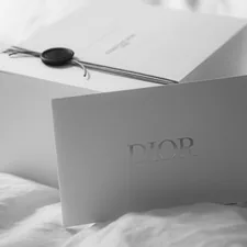Dior gift box with a card on white fabric related to Sweet Dreams with Ever After High Bedding