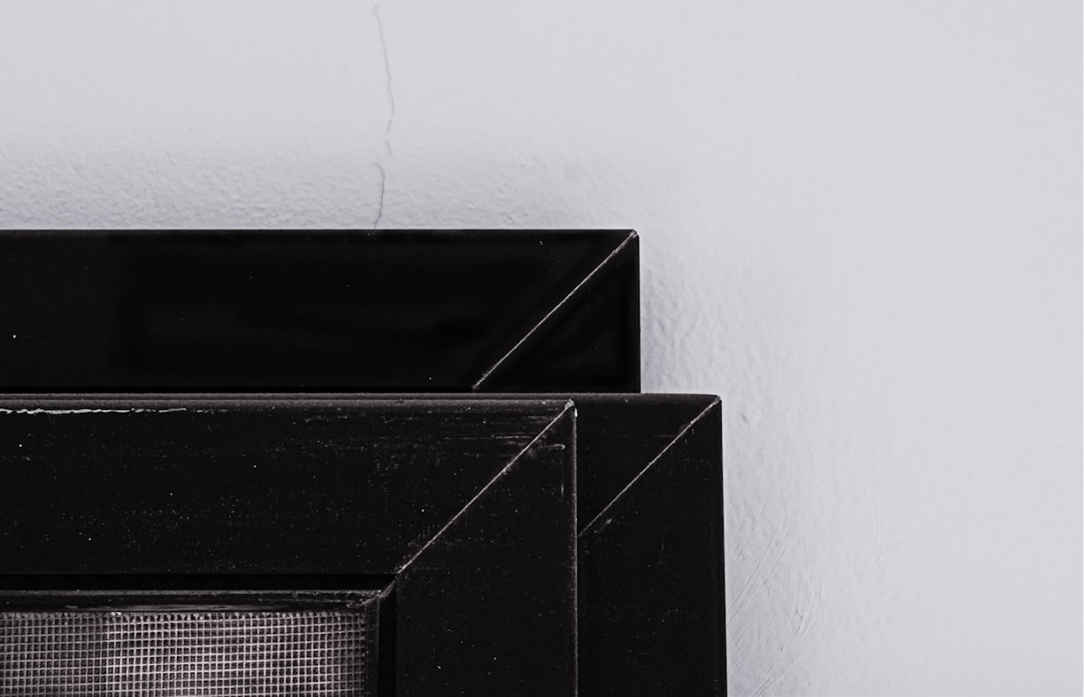 Discarded mosquito net panels lying against wall related to Elevate Your Home Decor with Style: Sideboard Black Gloss