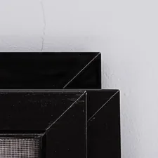Discarded mosquito net panels lying against wall related to Elevate Your Home Decor with Style: Sideboard Black Gloss