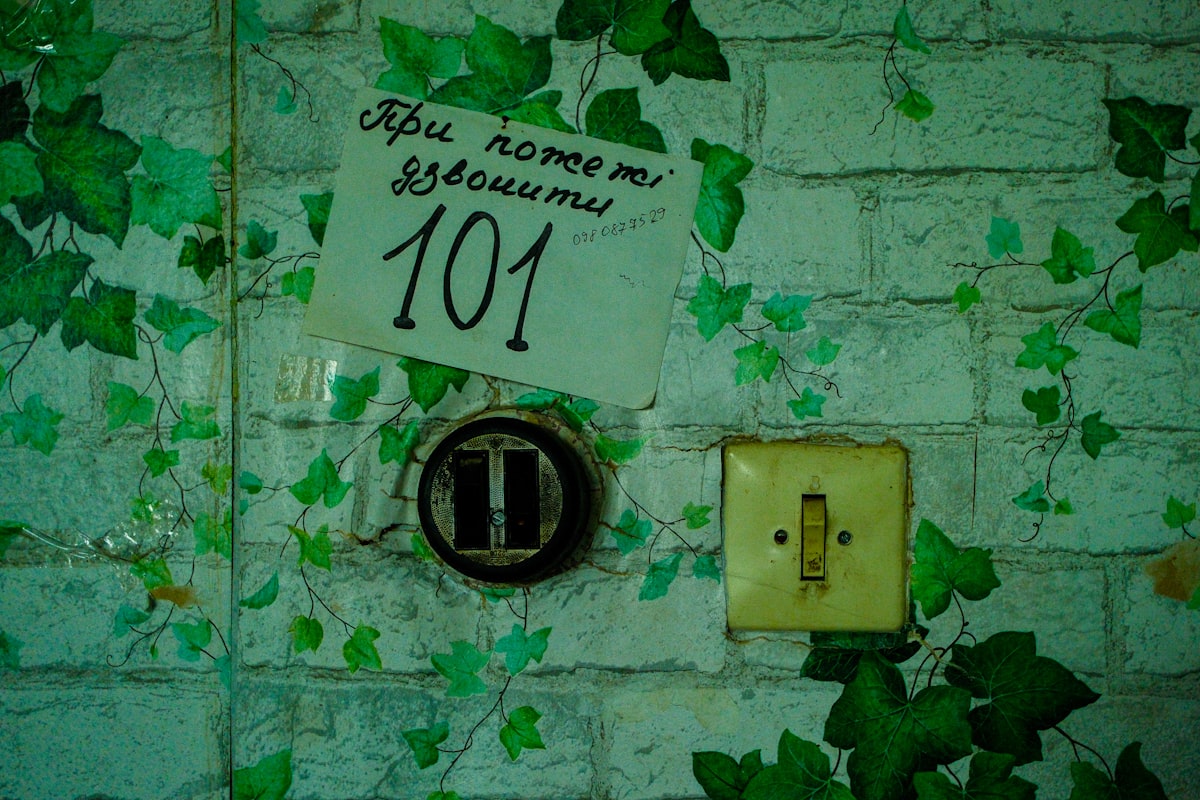 Door with number 101 and a light switch. related to Elevating Your Entrance: Innovative Entryway Wall Decor Ideas