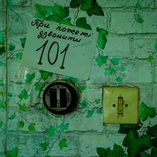 Door with number 101 and a light switch. related to Elevating Your Entrance: Innovative Entryway Wall Decor Ideas