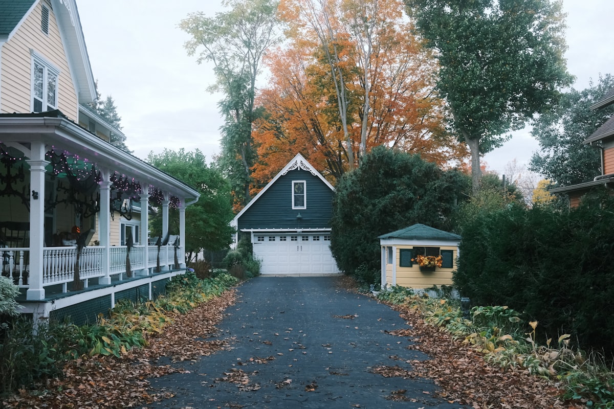 Driveway leading to a garage with autumn trees. related to Discover the Charm of Romantic Bed and Breakfasts in Michigan