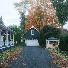 Driveway leading to a garage with autumn trees. related to Discover the Charm of Romantic Bed and Breakfasts in Michigan