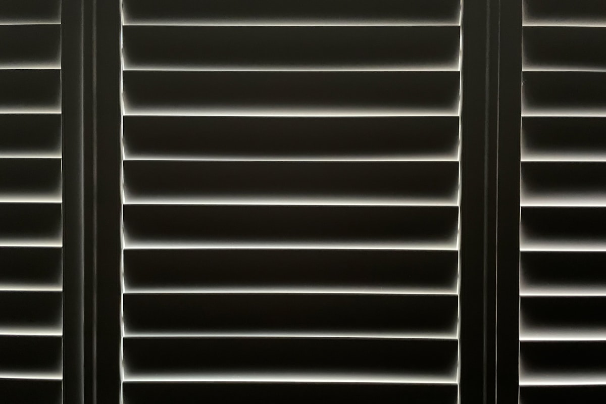 Early morning sun through shutters. related to Elevate Your Windows: Vertical Blind Valance Options