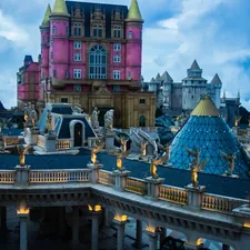 Elaborate fantasy castle complex with ornate architecture and statues. related to Transform Your Child's Room with Enchanting Princess Castle Beds