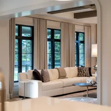 Elegant living room with large sofa and windows related to Valances and Drapes: Elevating Your Home's Style