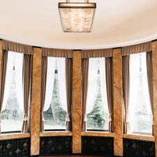 Elegant room with large windows and ornate columns related to Wood Valances for Windows: Enchanting Window Treatments