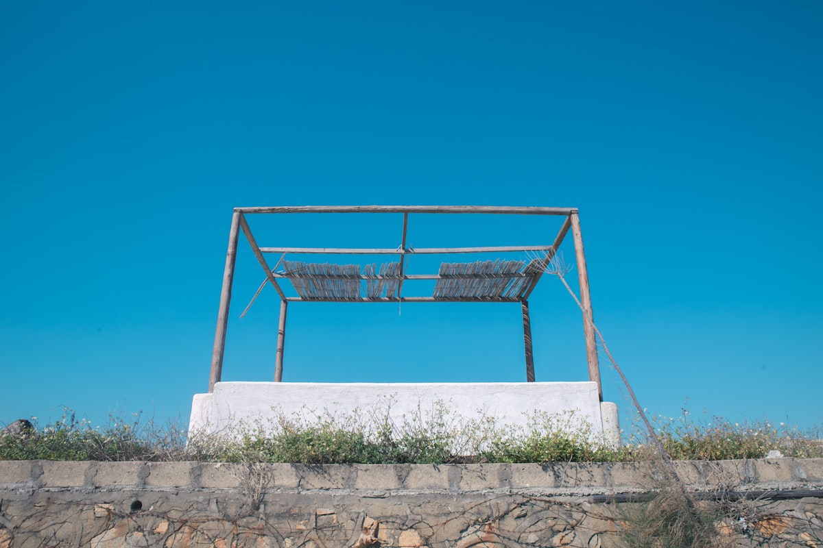 Empty metal structure against a clear blue sky related to Create Your Dream Retreat: A Step-by-Step Guide to Making a Canopy Bed