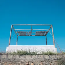 Empty metal structure against a clear blue sky related to Create Your Dream Retreat: A Step-by-Step Guide to Making a Canopy Bed
